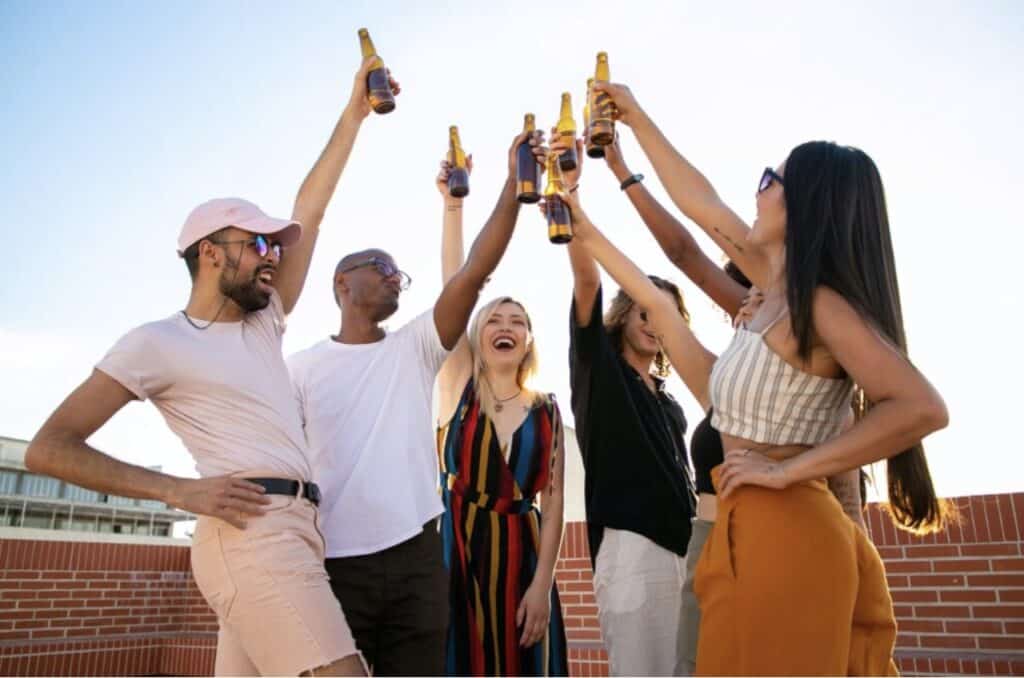 Group of People Toasting Bottles