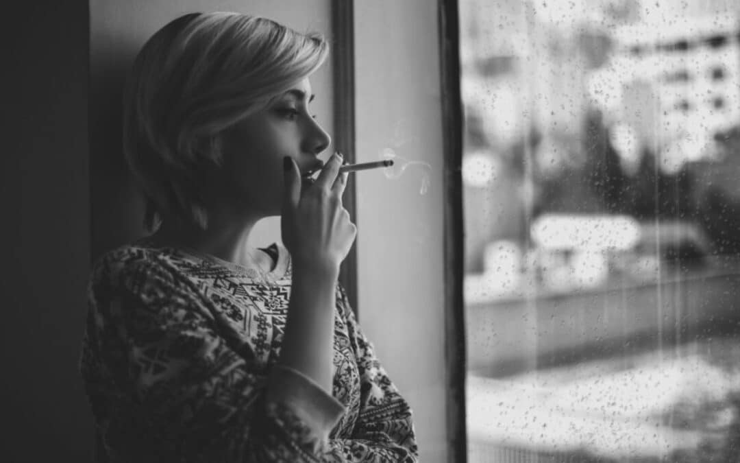 Woman Smoking Inside on a Rainy Day