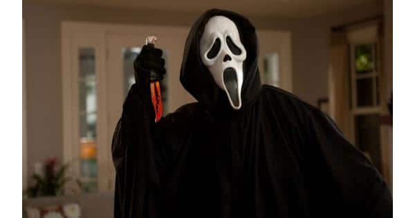Ghostface holding a bloody knife in the Halloween Movie Scream
