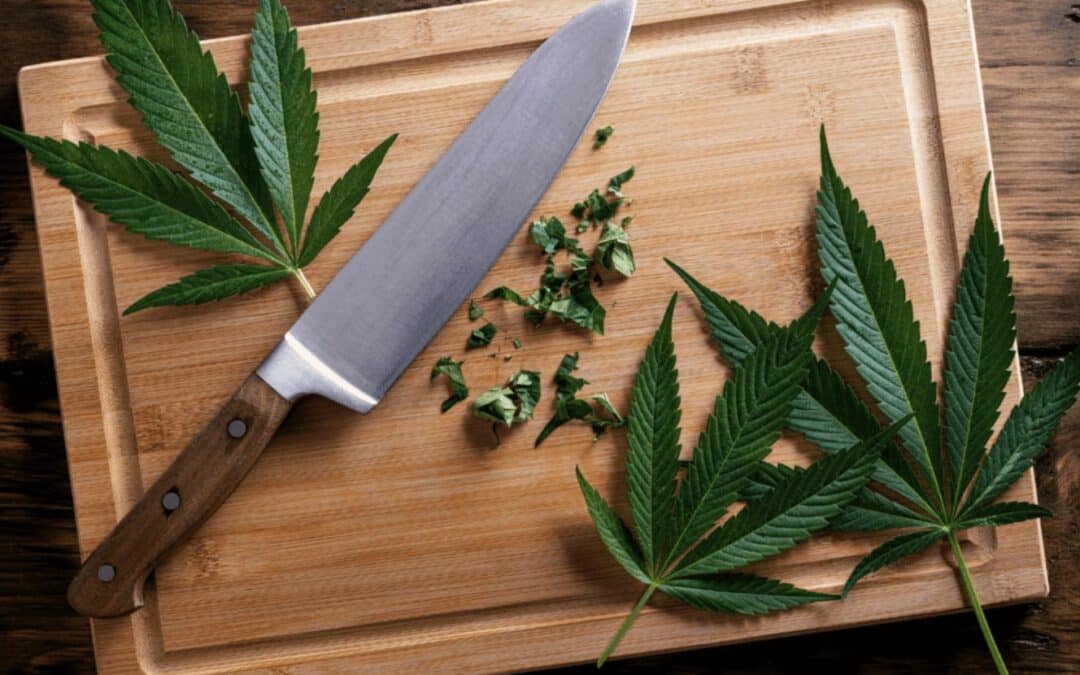 Cannabis Leaves on a Cutting Board With a Knife