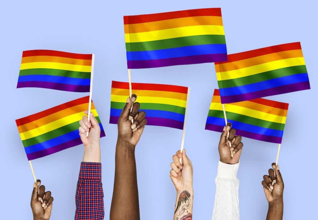 Hands Holding Pride Flags