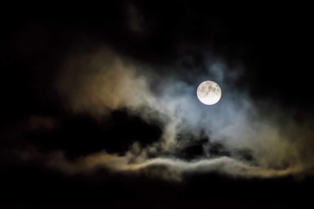 Moon Behind Clouds to Represent the Strain Moonshine Haze from Root Down