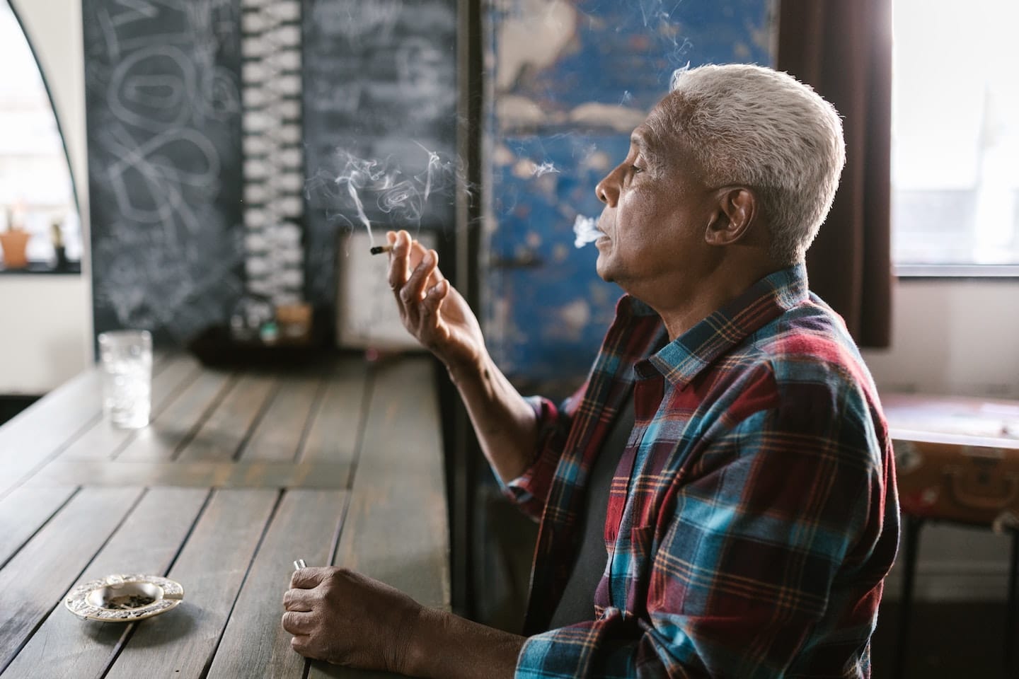 Old Man Smoking Weed to Represent The Strain Master Kush from Root Down