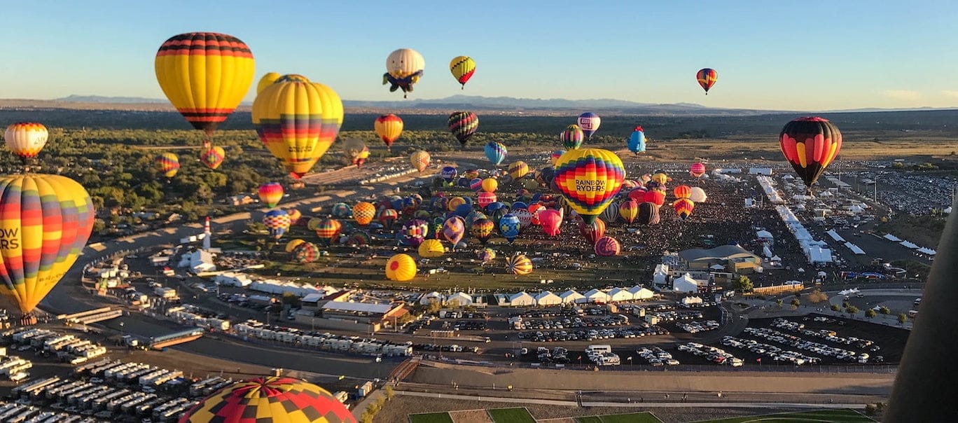 The Albuquerque International Balloon Fiesta above a parking lot