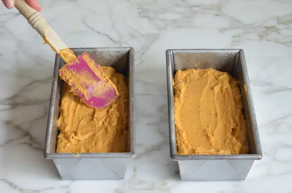 Cannabis-Infused Pumpkin Spice Bread Recipe Being Spread into Pans