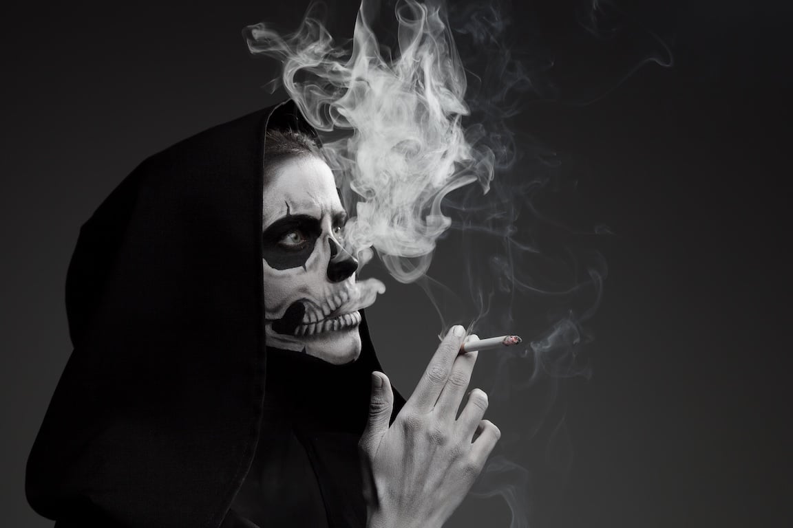 Man Dressed as a Skeleton Smoking a Joint