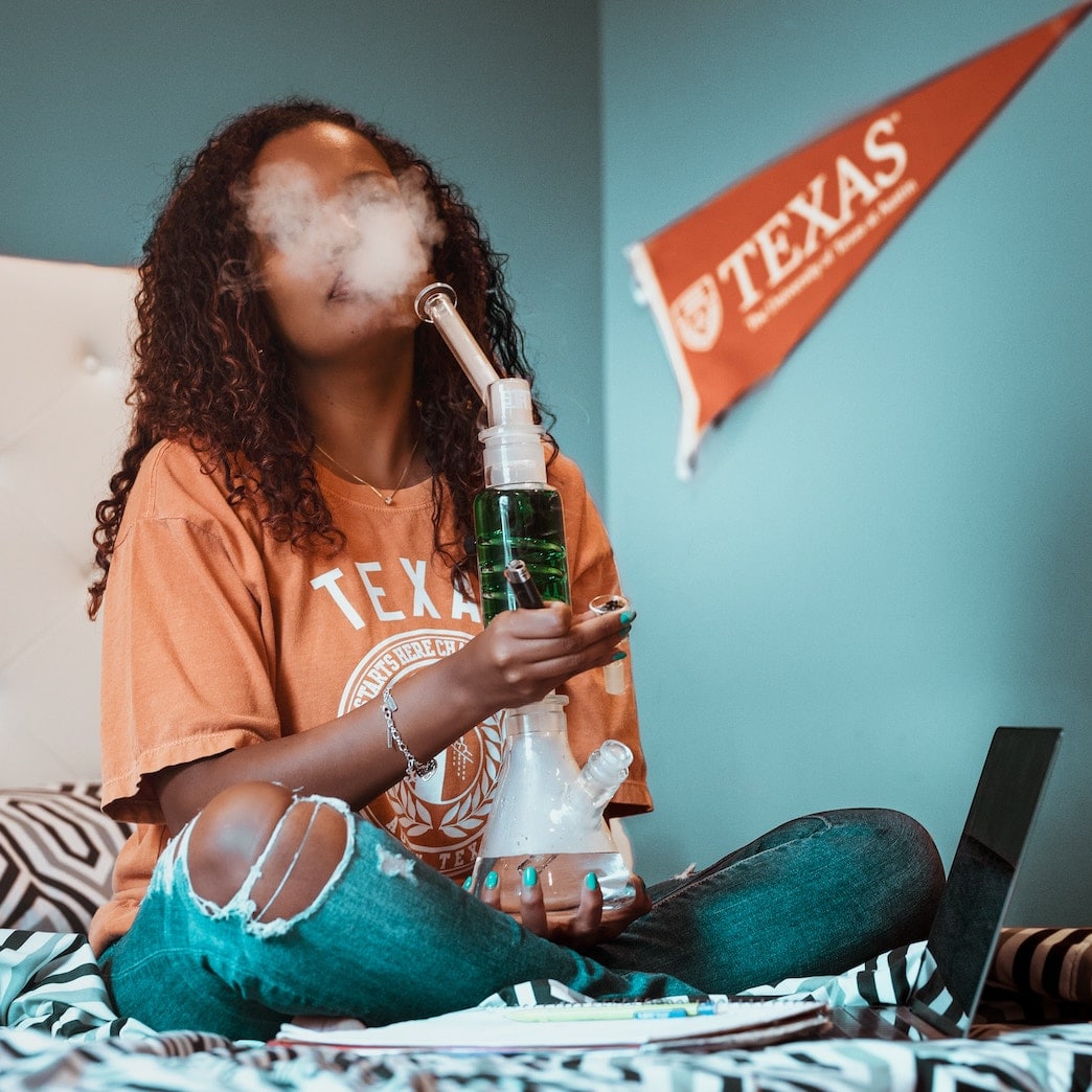 Woman Smoking Cannabis Weed from a Bong