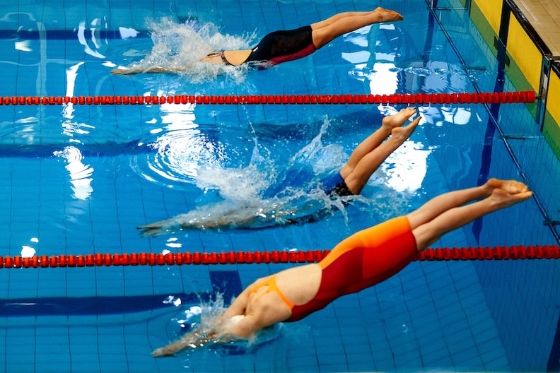 Three women athletes swimmers swimming championship