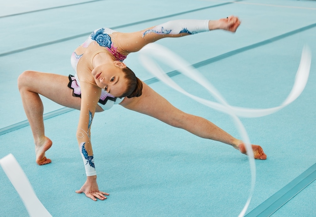 Woman, ribbon gymnastics and dance for performance, sports competition and action show. Dancer, rhy.