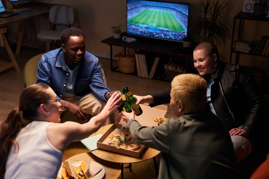 People Cheers Glasses at a Fantasy Football Game Day Party