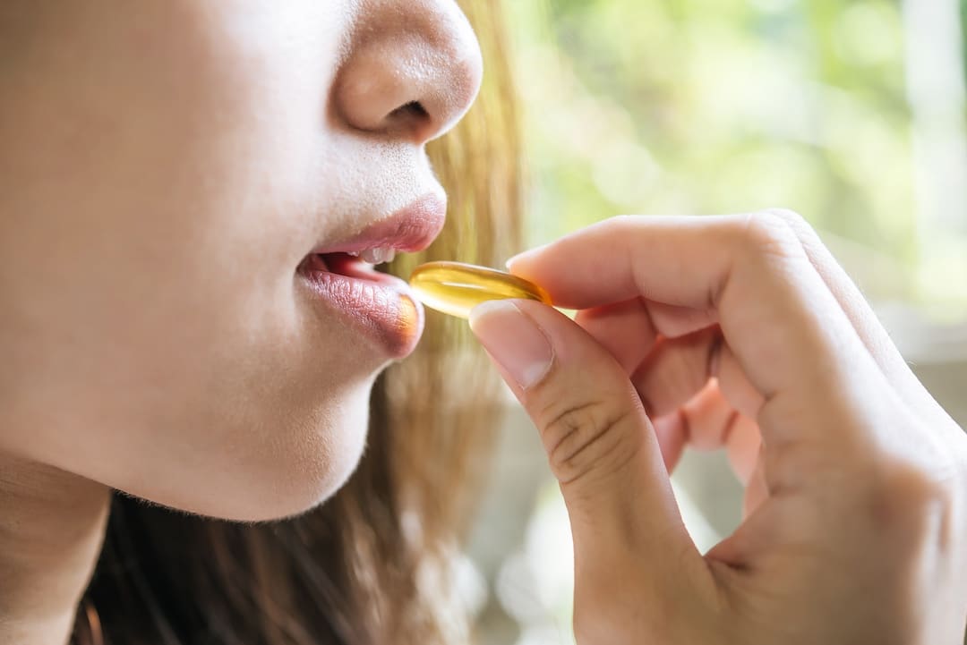 Person Taking a Capsule