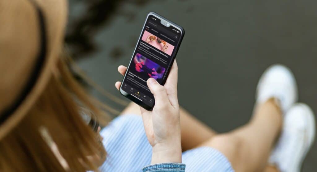 Woman scrolling through blogs on the Cinder App