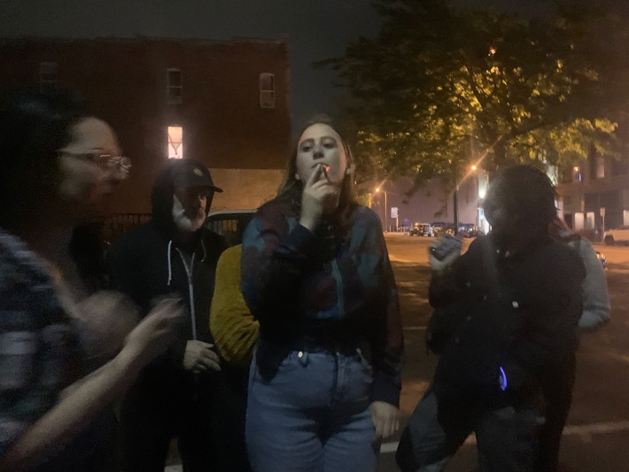 Girl Smoking a Rose Petal Joint With Friends Nearby