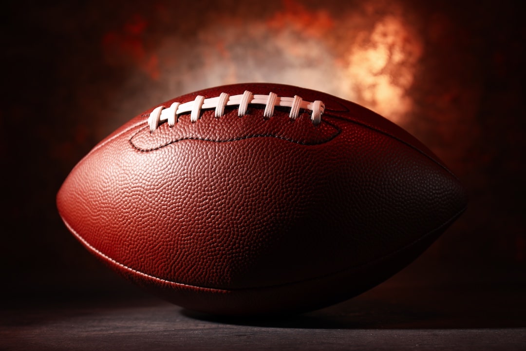 American football with fire in background
