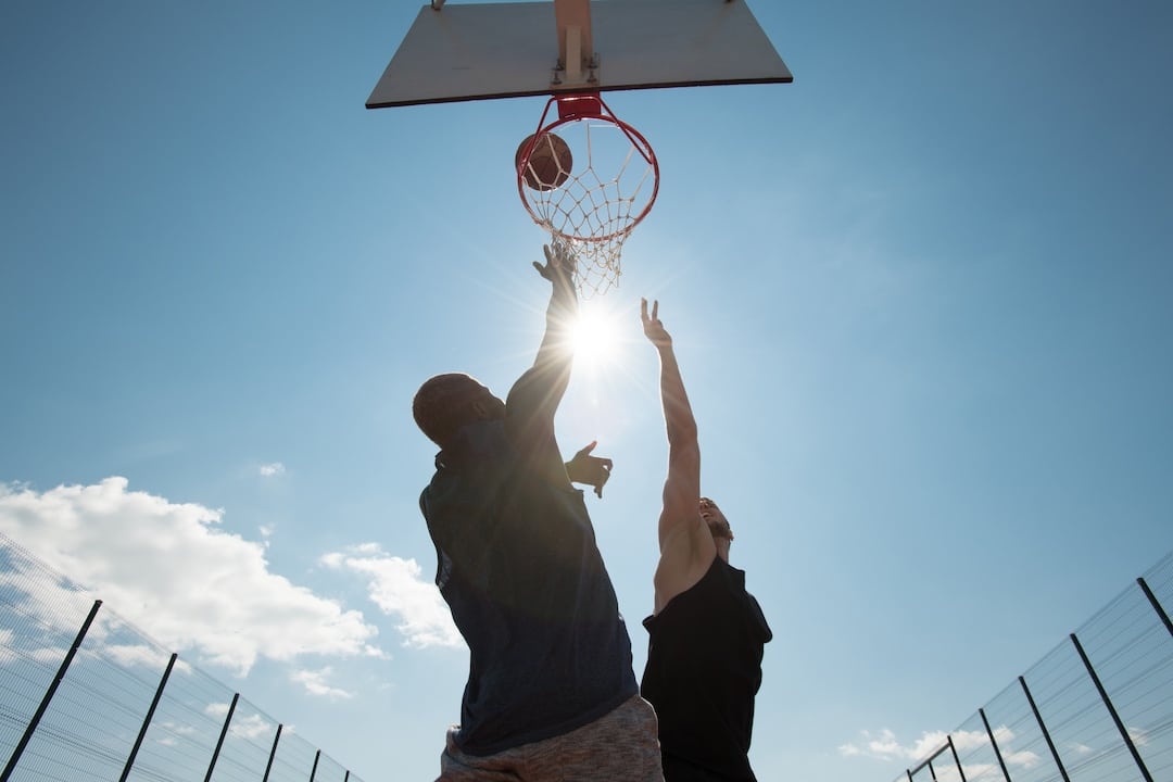 Two People Playing Basket Ball Shot from Below
