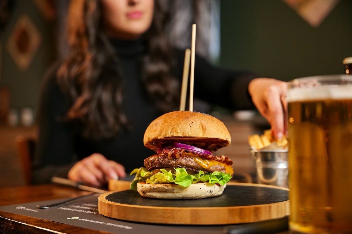 Person at a restaurant pub with a burger