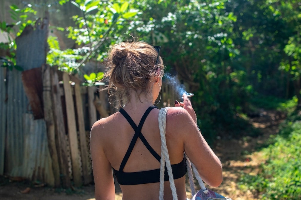 Female smoking a joint shot from behind