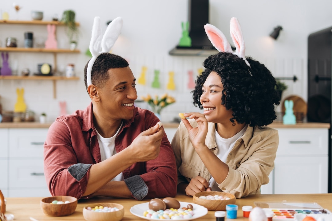 Couple handing each other Easter edibles