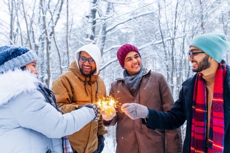 Image of a happy young friends with sparklers at Christmas party