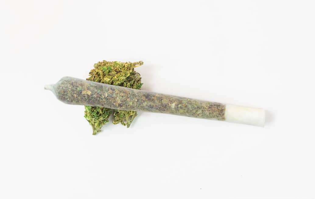 Marijuana Weed Cannabis Joint Pre-roll On Top of a Nug