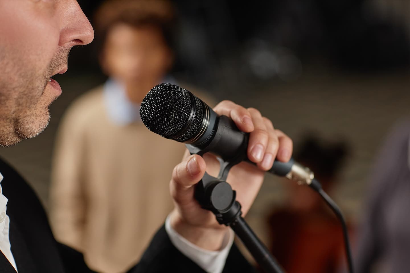 Close up of a man singing into a microphone