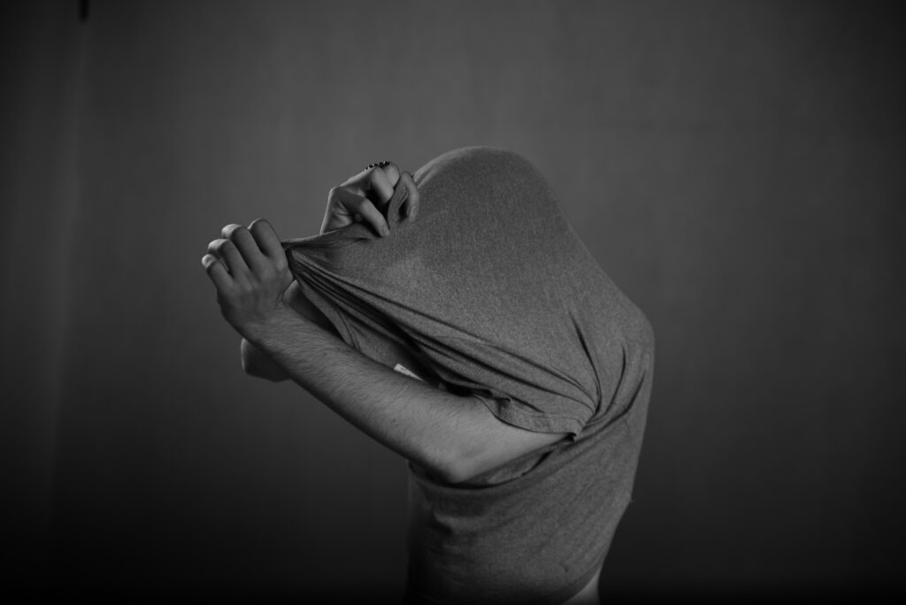 Man Taking Off Shirt in a Game of Strip Choker