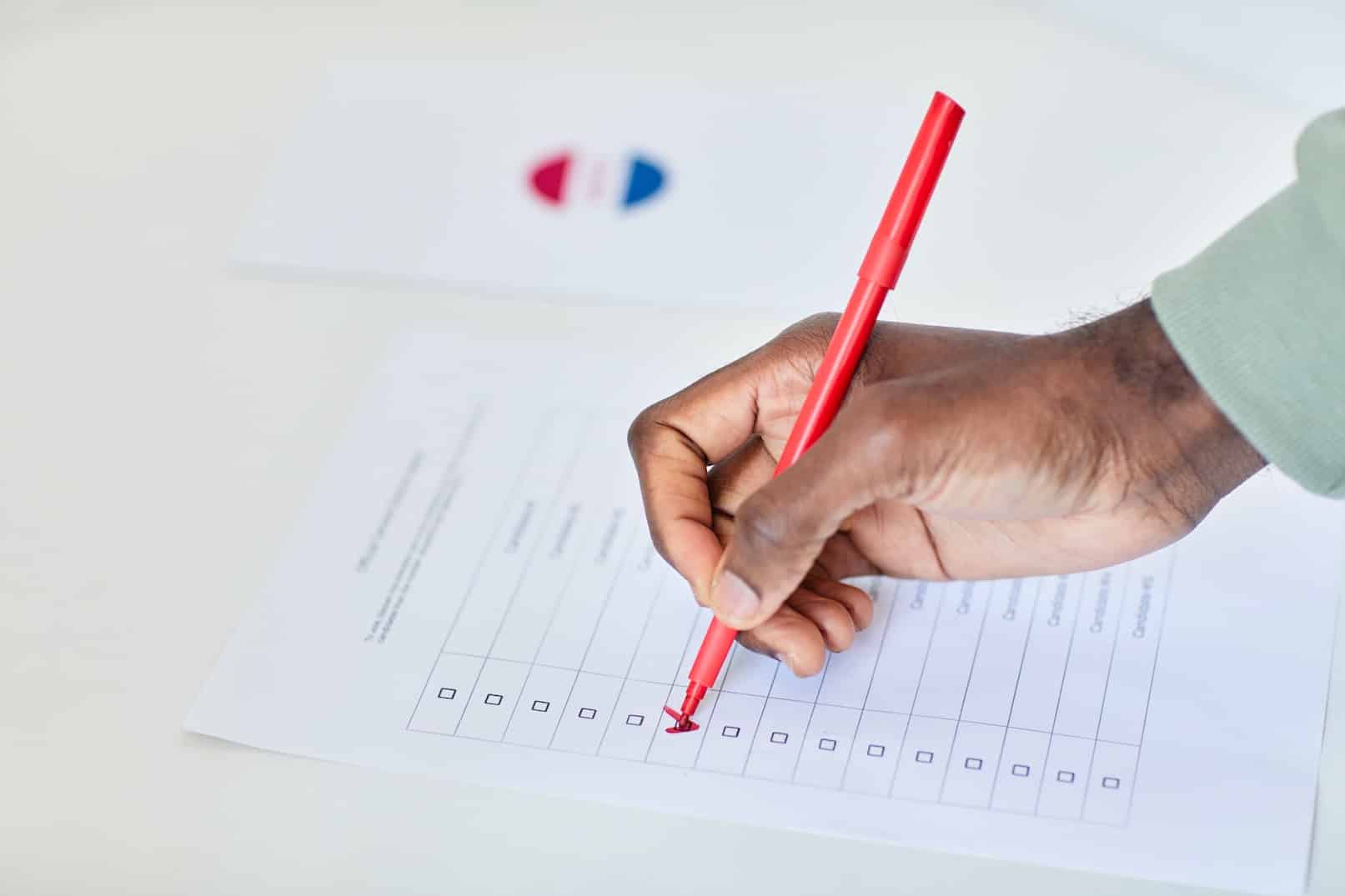 Person Filling Out a Poll Sheet