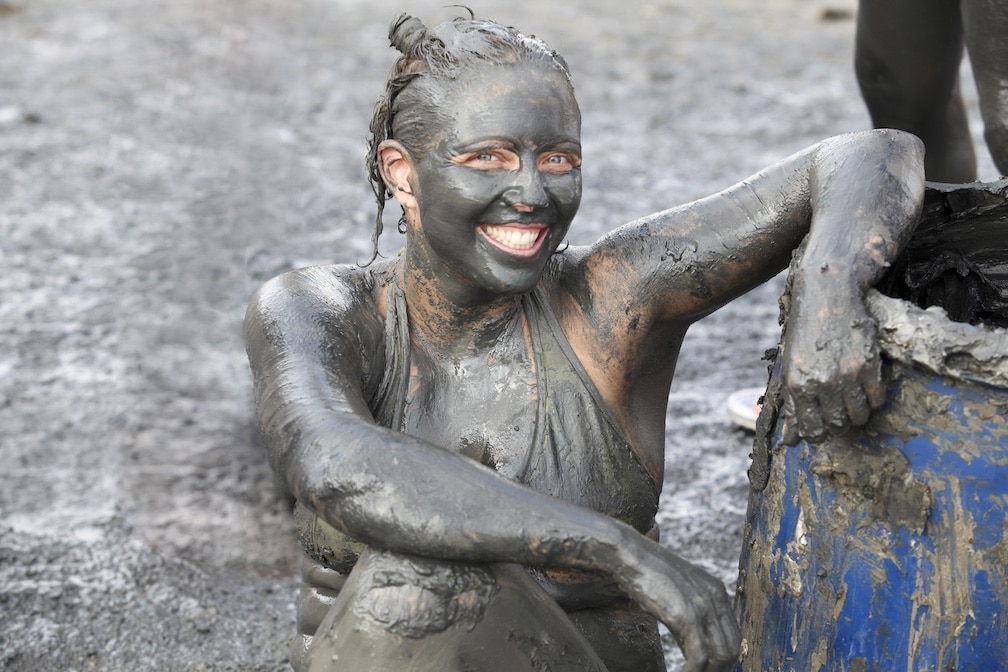 Woman covered in mud to represent the strain Dirty Girl
