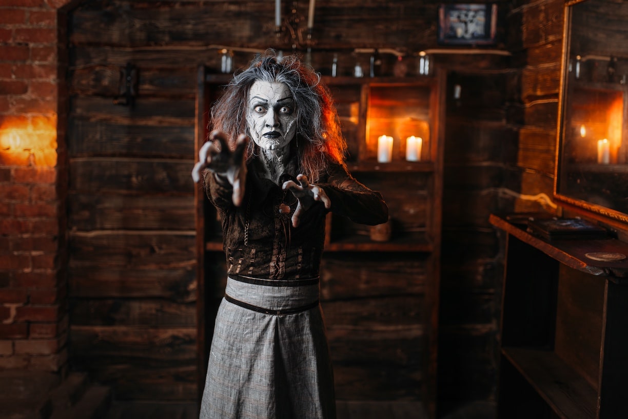 Scary witch hands out, front view, spiritual seance. Female foreteller calls the spirits, terrible fortune teller