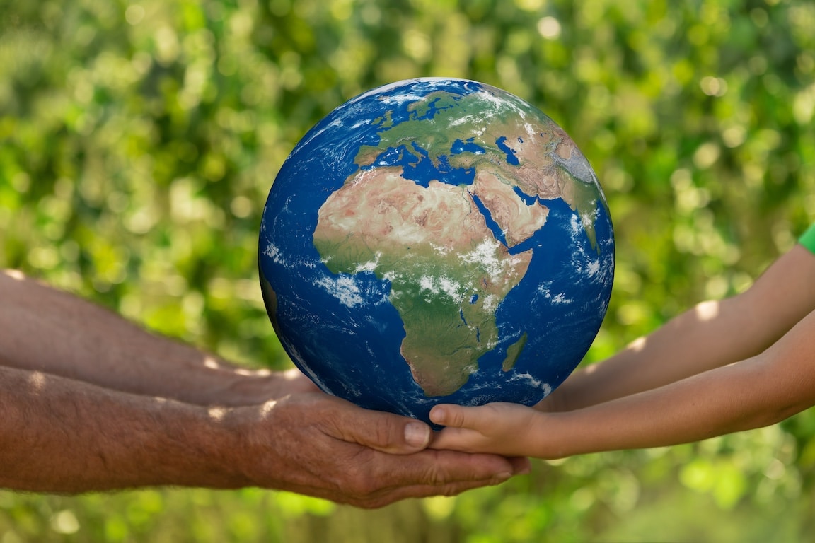 Two people holding the world in their hands