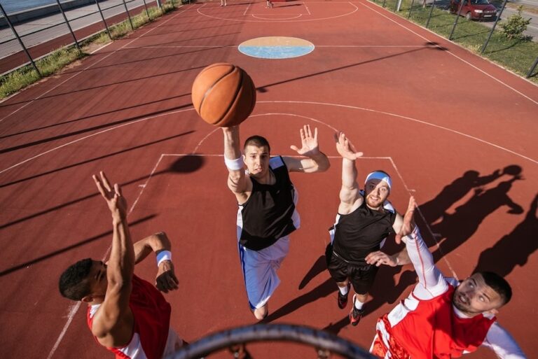 A young basketball player scoring a slam dunk