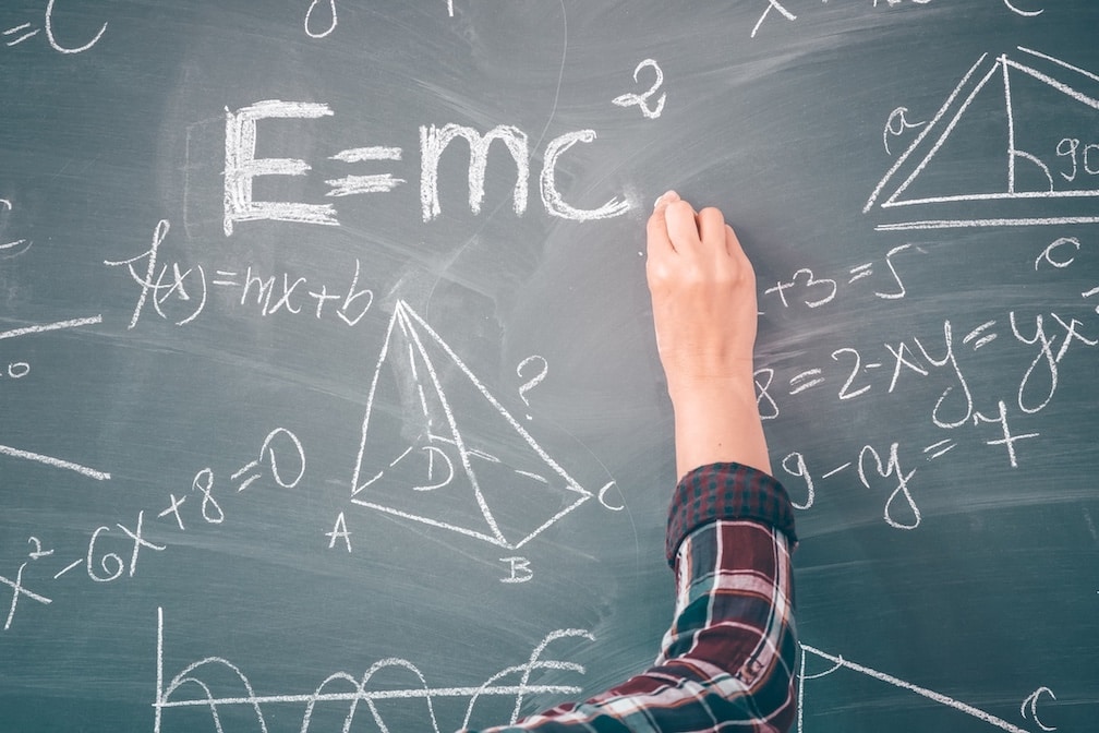 Einstein math equation being written on classroom chalkboard