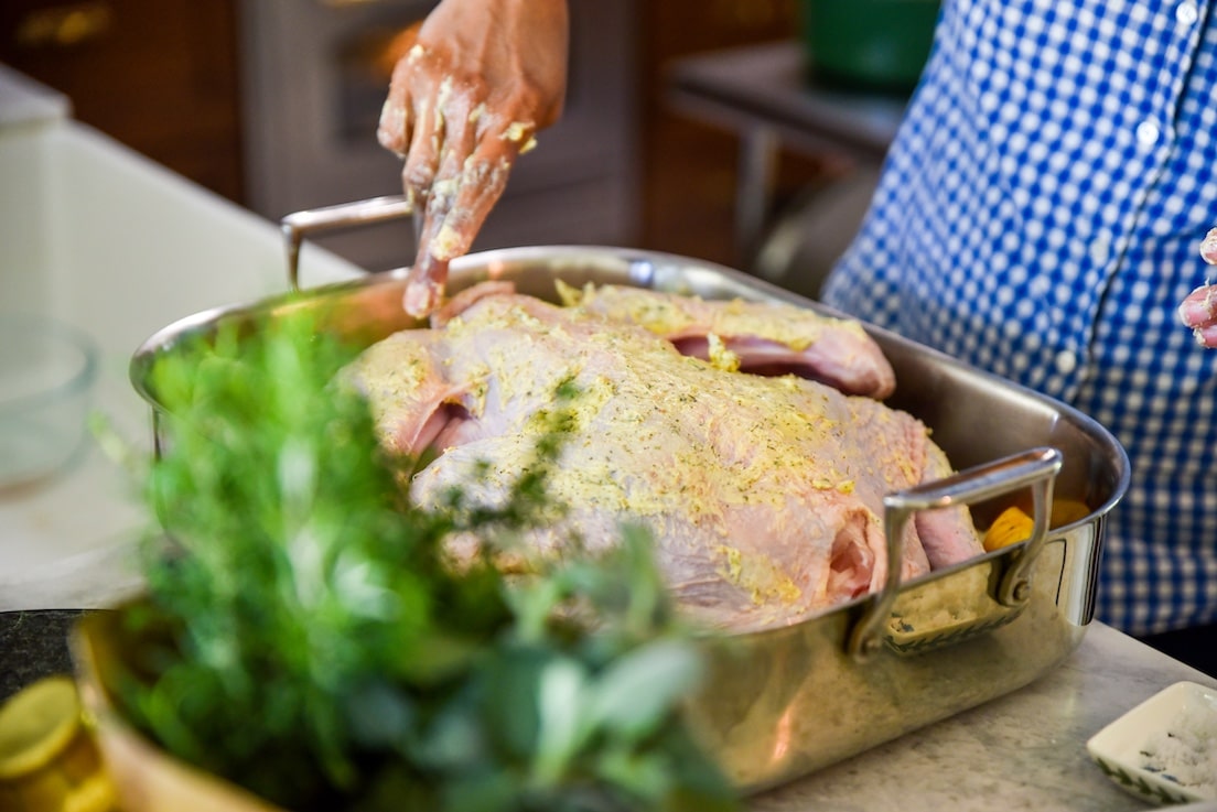 Thanksgiving Turkey Being Lathered in Butter