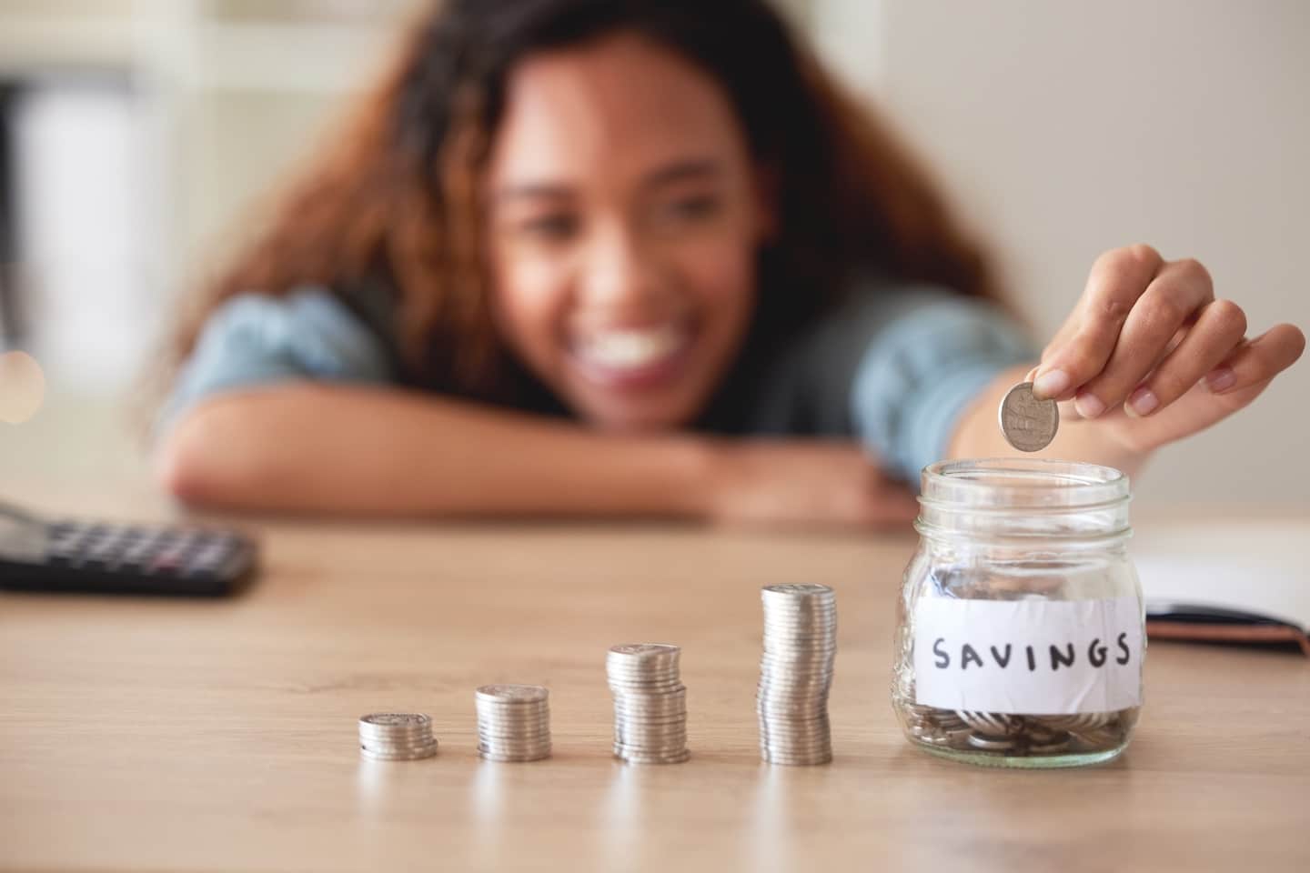 Woman Saving Coins in a Jar