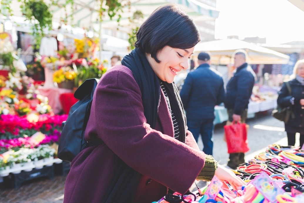 Woman looking at crafts at a street market fair